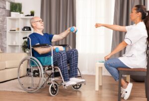 Man in wheelchair using dumbbell